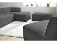 Kampinė modulinė sofa MEGEVE, tamsiai pilka, su pufu svetainės interjere