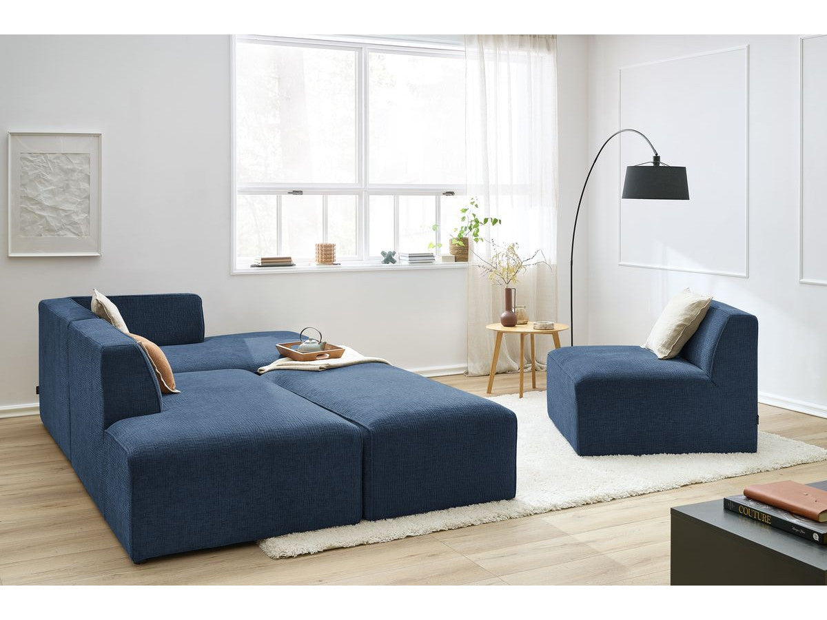 Kampinė modulinė sofa su pufu ir tamsiai mėlyna moderniame interjere