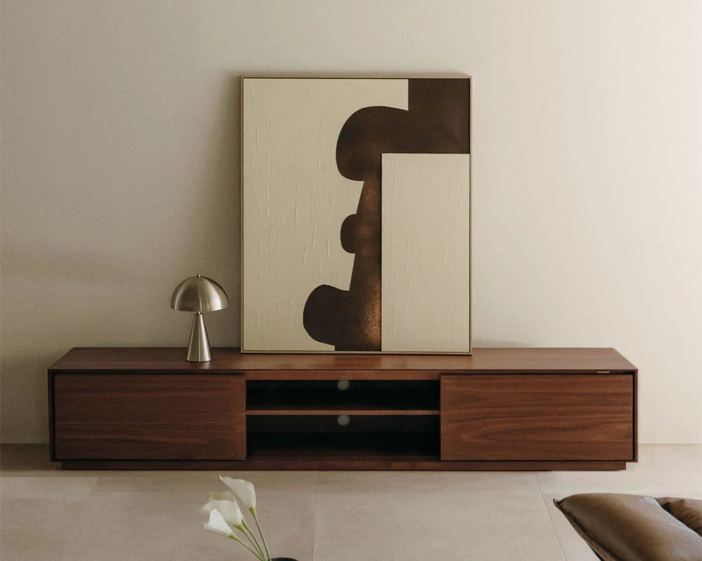 Modern living room with wooden TV stand, abstract artwork, and minimal decor.